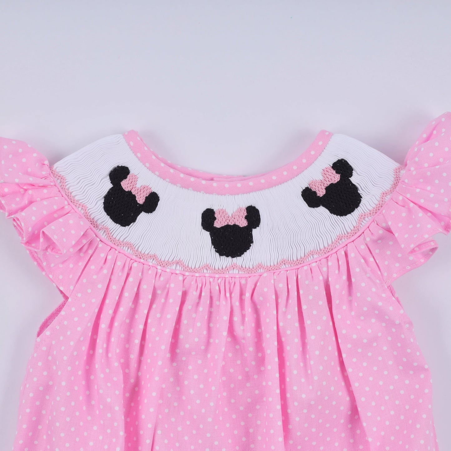 Pink character hand smocked dot ruffle bubble